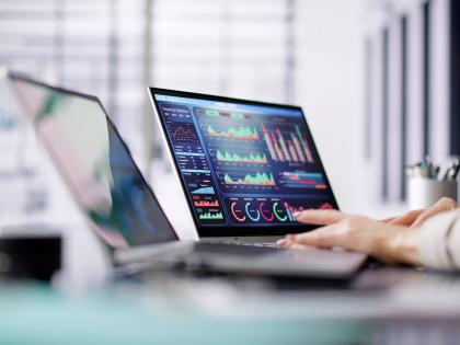 Critical application performance dashboard displayed on a laptop screen, showing real-time analytics, charts and operational metrics in a modern office environment.