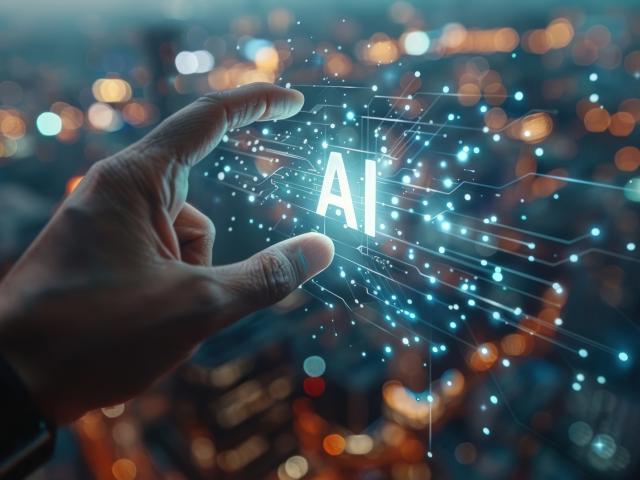 hand reaching out to touch an ai symbol glowing with light