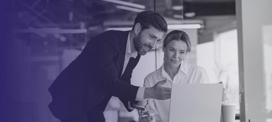 Two people looking at a computer