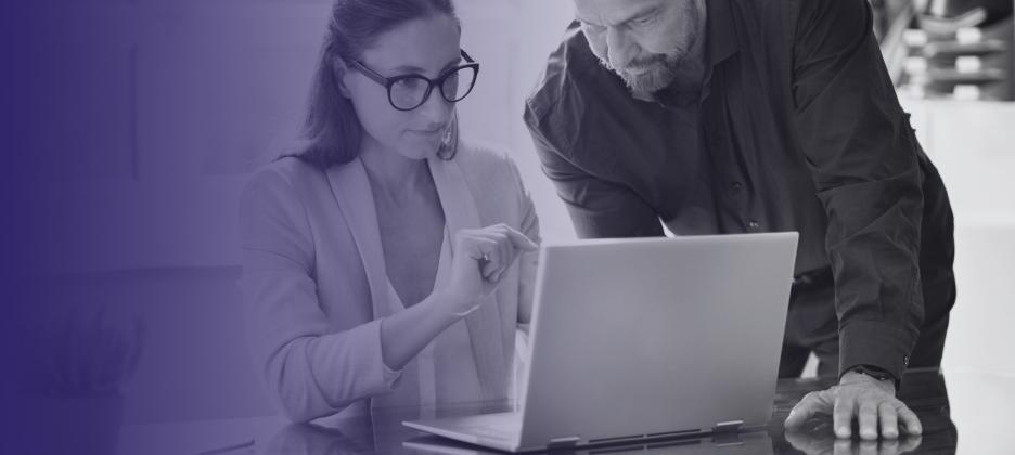 Two people looking at laptop