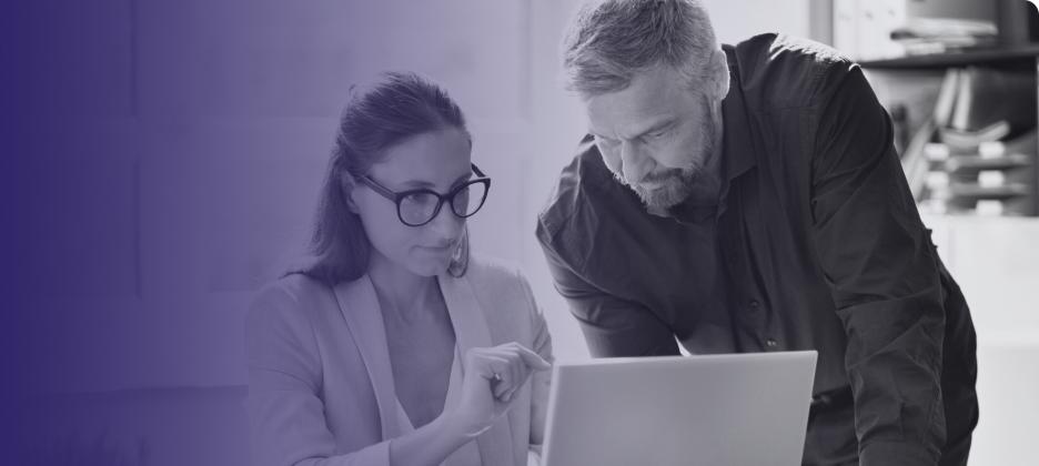 Two people looking at laptop
